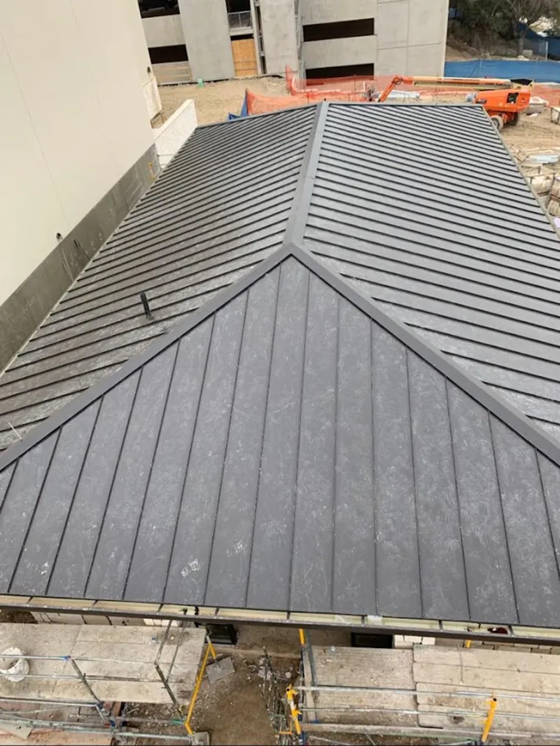 Commercial metal roof construction with crane equipment in Waterloo